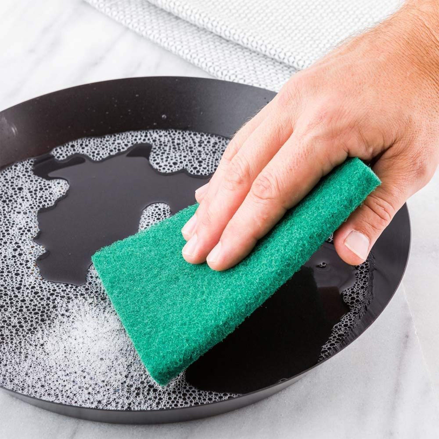 Set of 10 aqua green scrub sponges for cleaning.