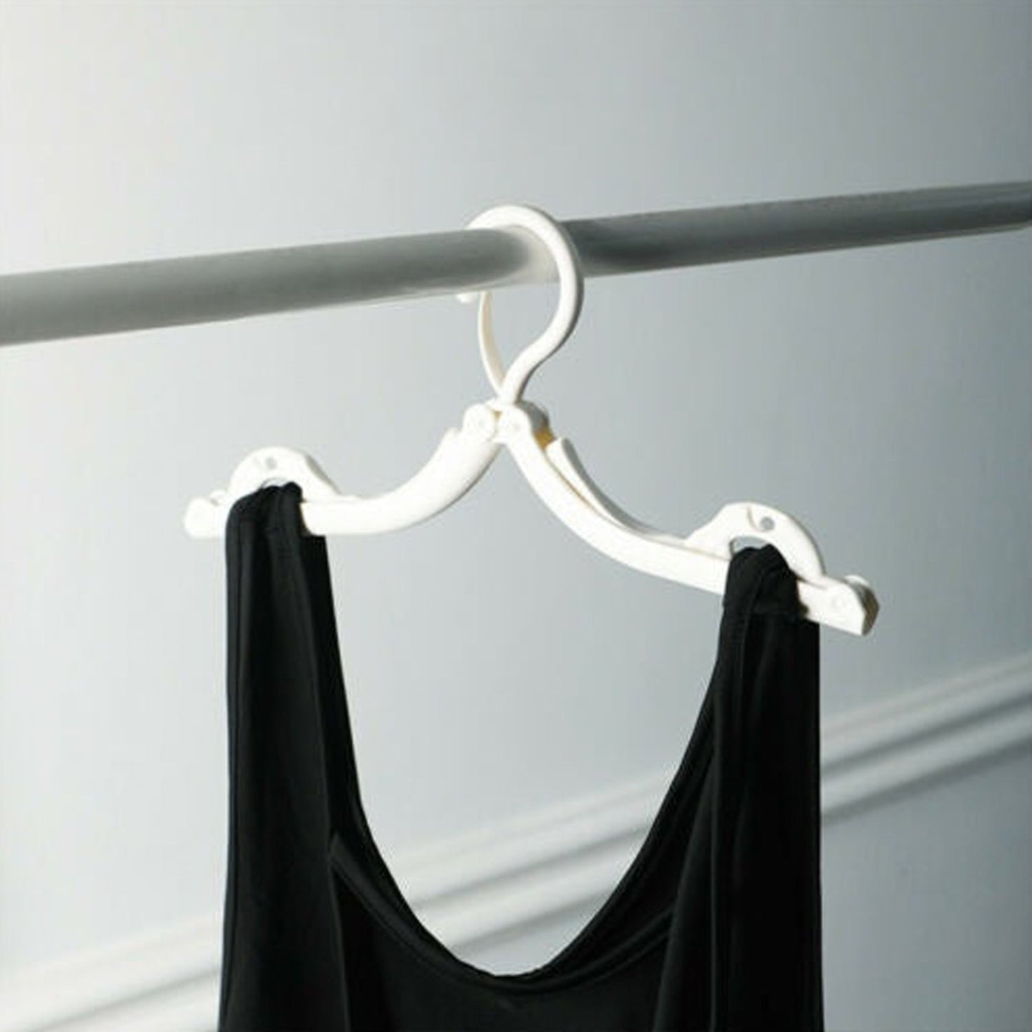 Compact foldable hangers for travel and home use, suitable for a range of clothing.