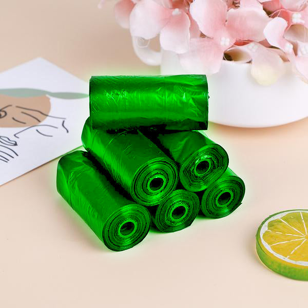 Eco-friendly garbage bag rolls in green for household waste disposal.